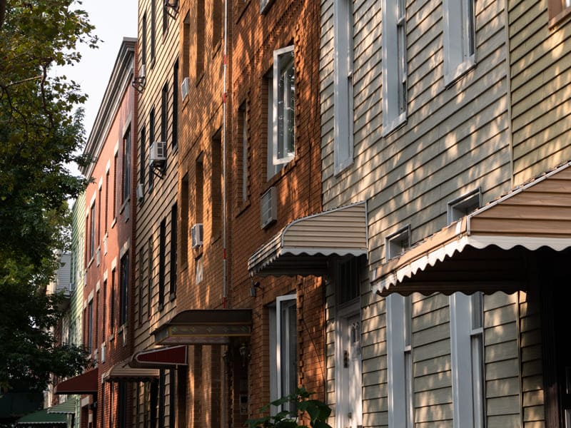 Row of Manhattan, NY buildings featuring expert siding by C. Johnston Roofing & Waterproofing.